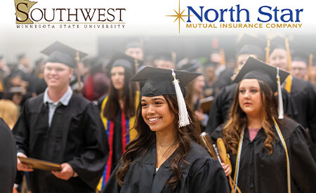 Graduates in caps and gowns at a ceremony, with SMSU and North Star Mutual Insurance Company logos displayed.